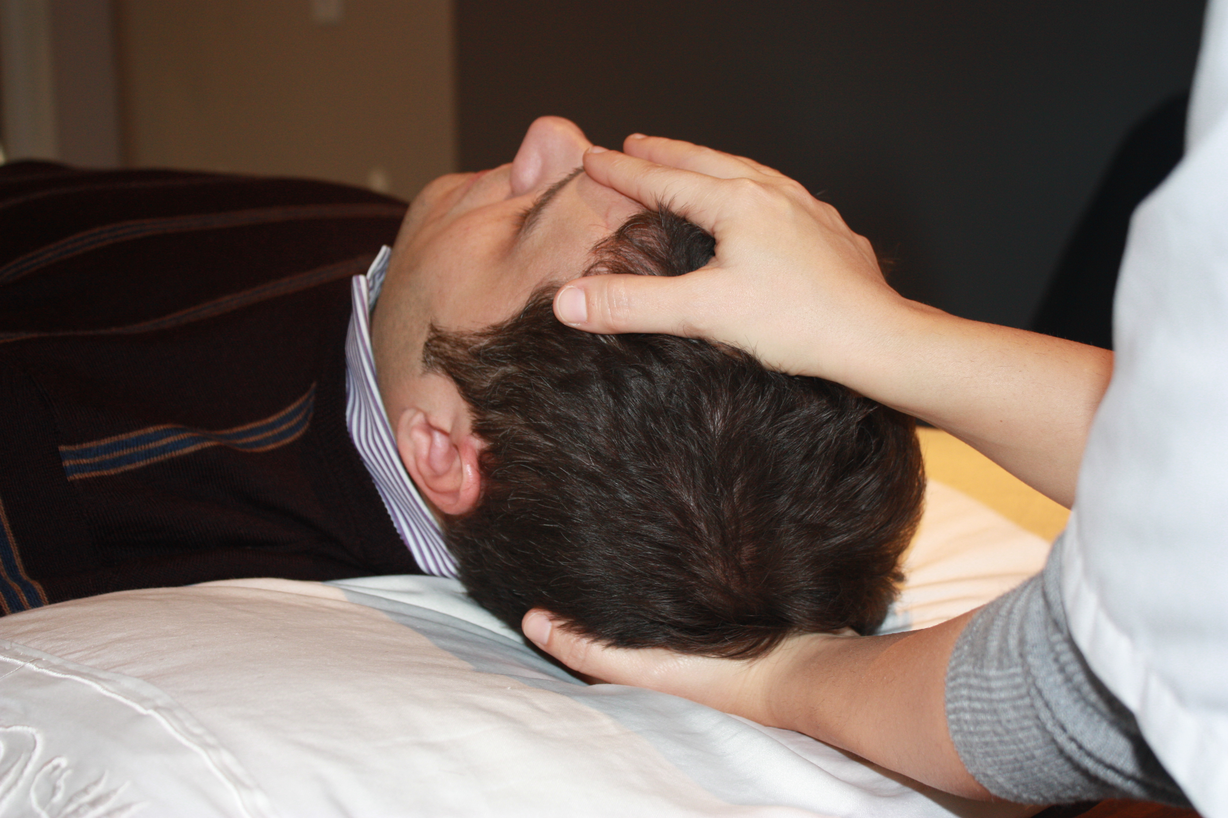 Katia demonstrates cranial manipulation on a patient
